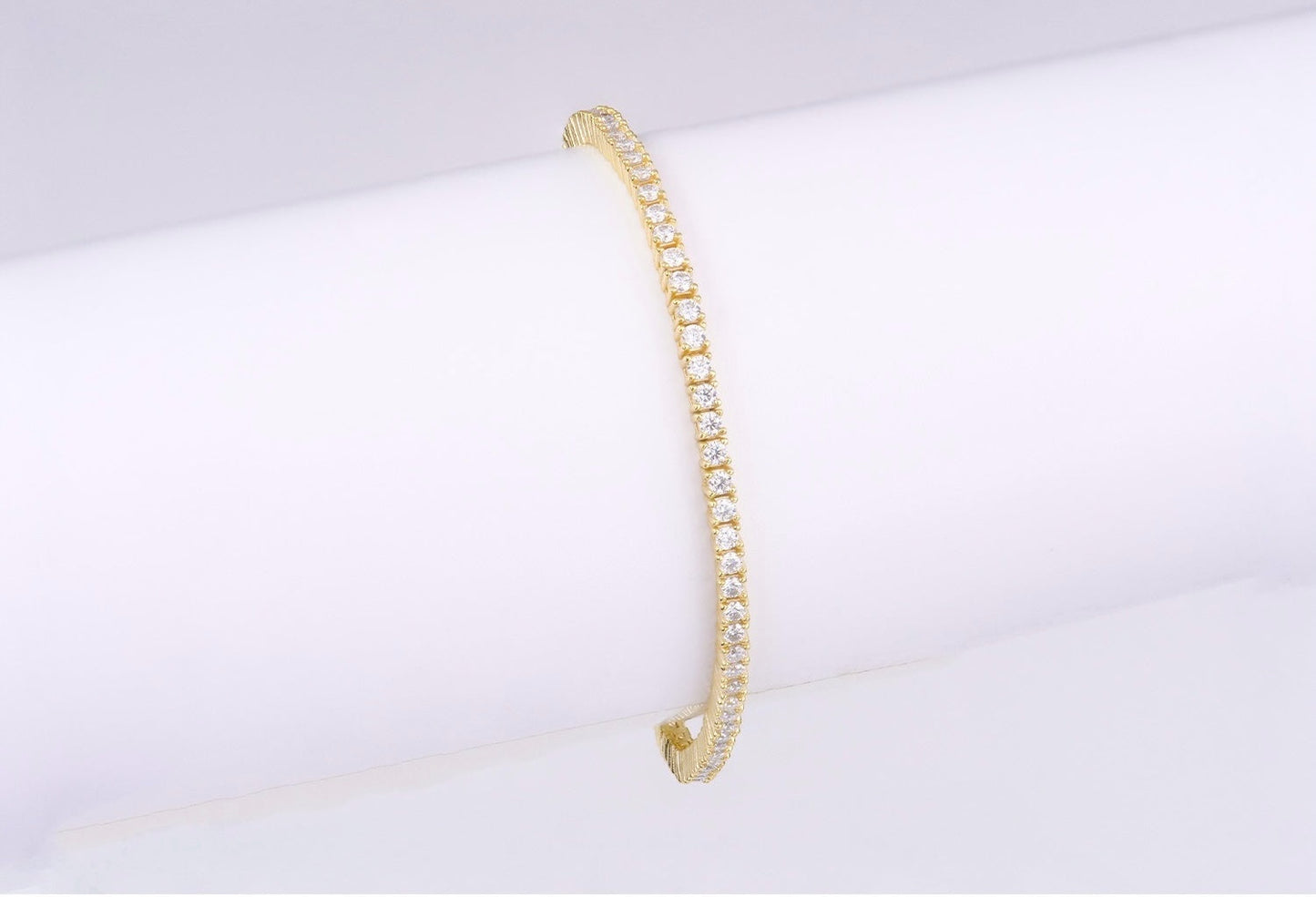 Luxe 18K gold plated moissanite tennis bracelet with 2mm round stones set in 925 sterling silver, displayed on a white background.